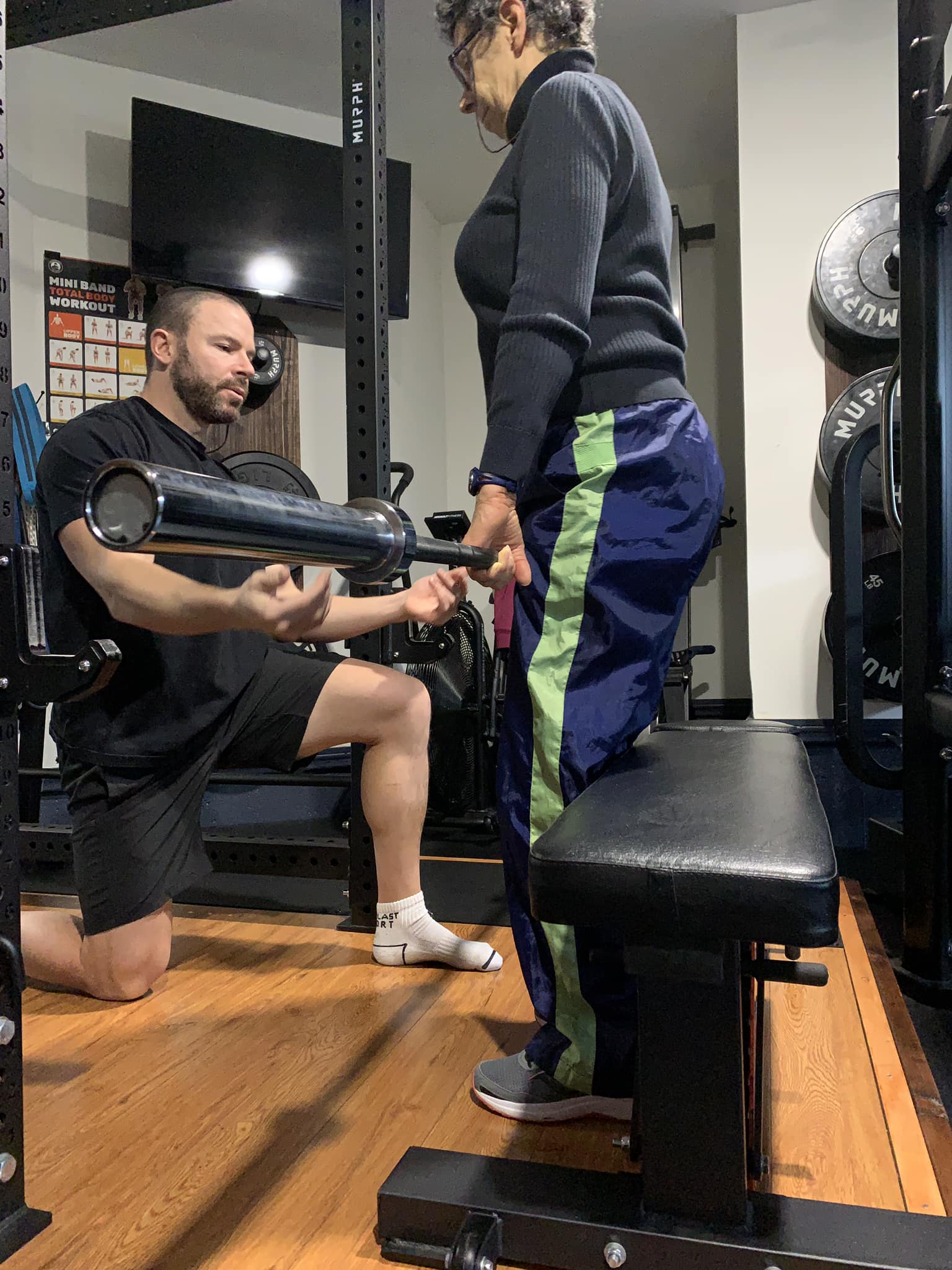 Kyle coaching a client through a lift in the SPH studio
