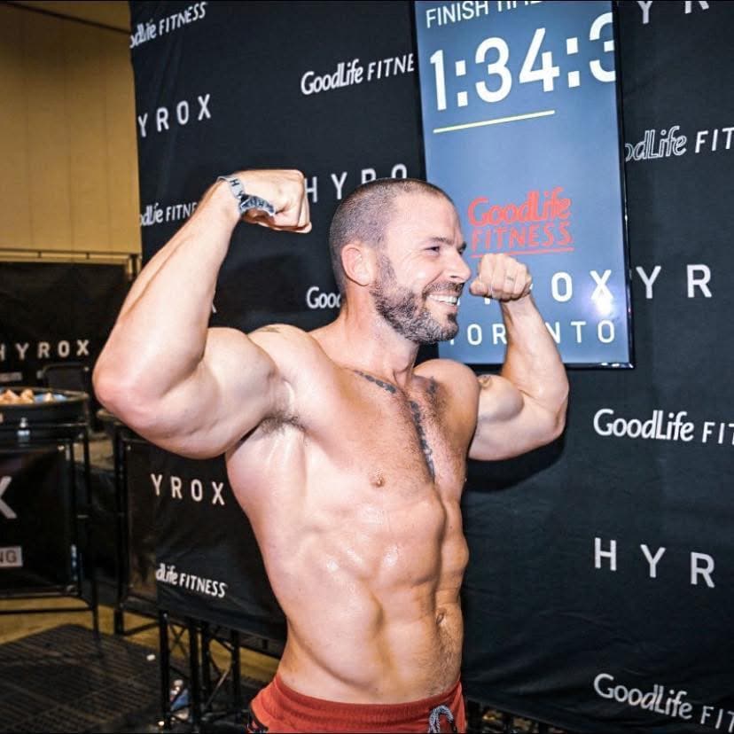 Kyle Murphy flexing after finishing HYROX Toronto