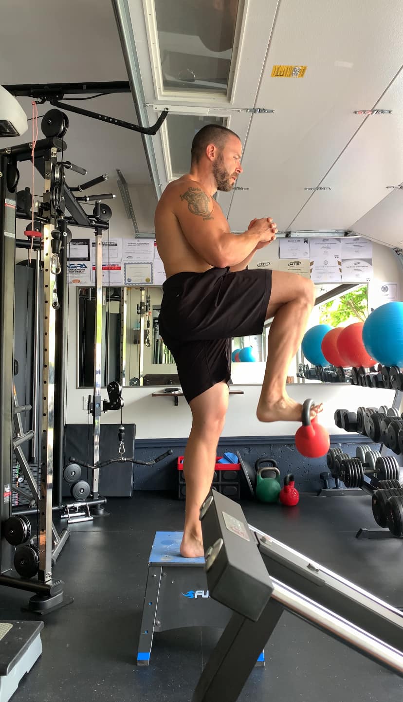 Kyle demonstrating a knee drive conditioning movement